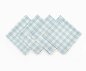 Set of light blue and white checked cotton napkins laid flat