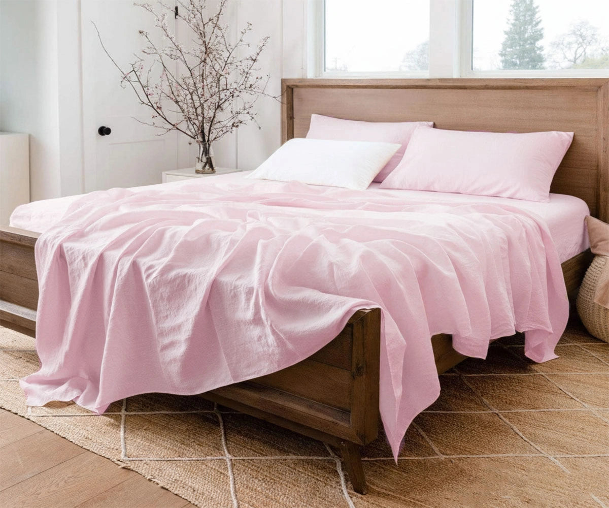 Pastel pink linen sheet set made from 100% European flax linen, soft washed and breathable for year-round comfort.