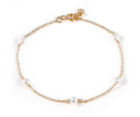 Dainty freshwater pearl chain charm bracelet worn on wrist, 4mm pearl gold bracelet for women, elegant everyday jewelry accessory