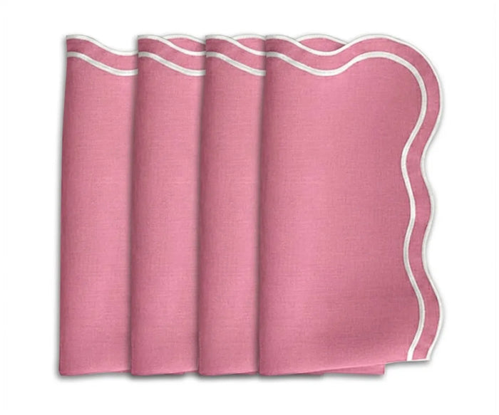 Soft peony pink scalloped cotton dinner napkins styled on an elegant wedding table with romantic peony-inspired table decor.