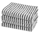 Black pinstripe linen napkins neatly folded on a modern dining table for elegant everyday dining