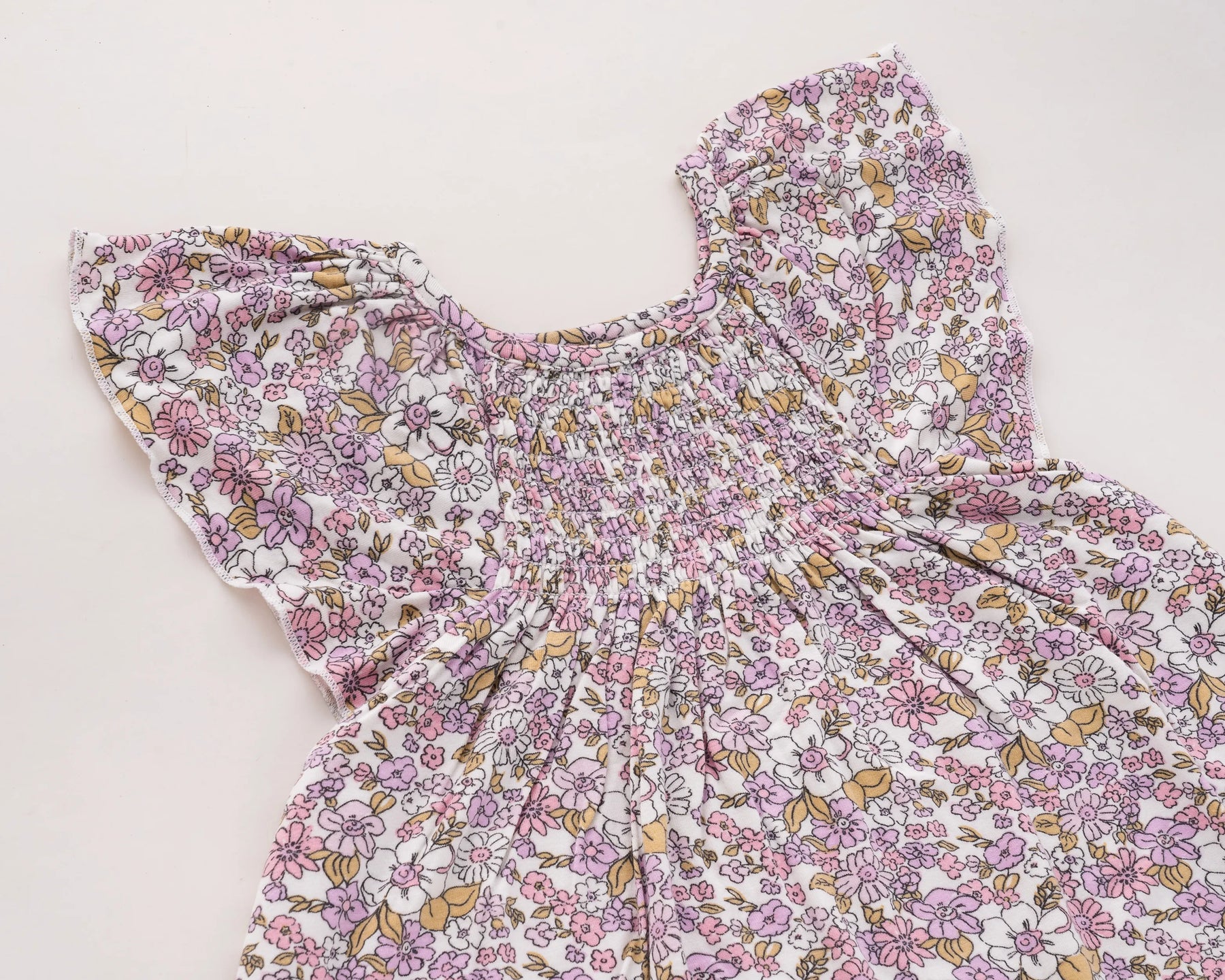Adorable pink flower print baby girl dress made from 100% cotton, featuring a sleeveless frock design perfect for parties and playtime, and a charming addition to any 100 organic cotton clothing collection.
