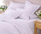 Pink scalloped edge cotton bedding set with fitted sheet and pillowcases for elegant bedroom styling
