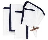 White cotton dinner napkins with navy blue piping trim, reusable cloth napkins for dining table decor, farmhouse dining, summer entertaining, dinner parties, weddings, and everyday meals.