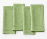 Four green napkins on a white background