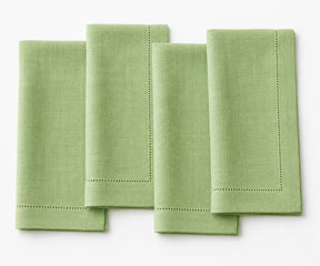 Four green napkins on a white background