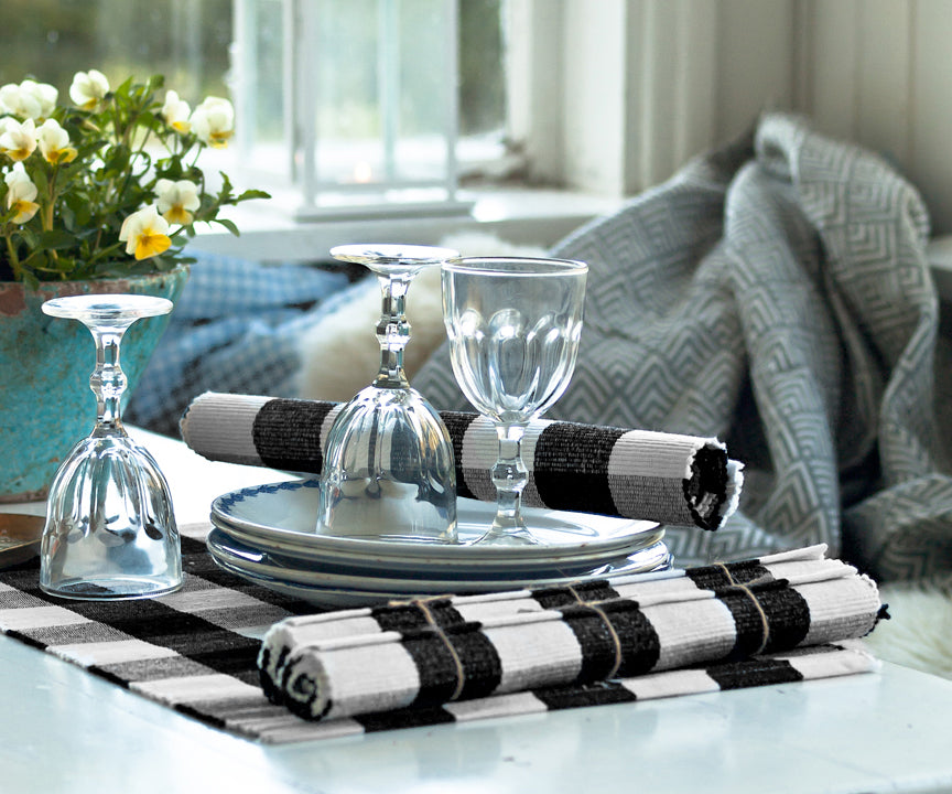 Black Placemats serve as a protective barrier between the table and plates, bowls, glasses, and utensils. 
