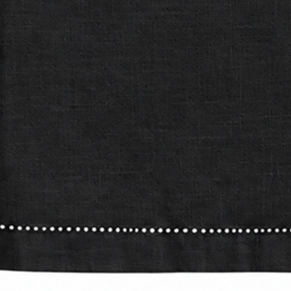 Close-up of black cotton linen tablecloth with detailed hemstitched border.