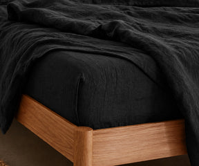 Black European linen fitted sheet made from premium flax linen for breathable comfort and sophisticated bedroom décor