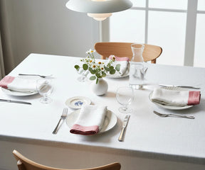 Red linen napkins with a simple plain border for an elegant, refined table setting.