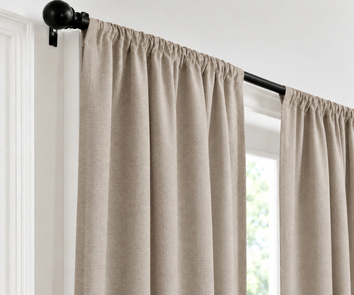 Dark flax plain cotton drapes mounted on a dark curtain rod in a brightly lit room.