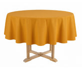Round table with a yellow tablecloth on a white background