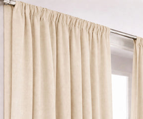 Neutral cream cotton curtains hanging on window rod