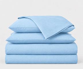 Light blue European linen bedding set made from 100% European flax linen, including a fitted sheet, flat sheet, and pillowcases.