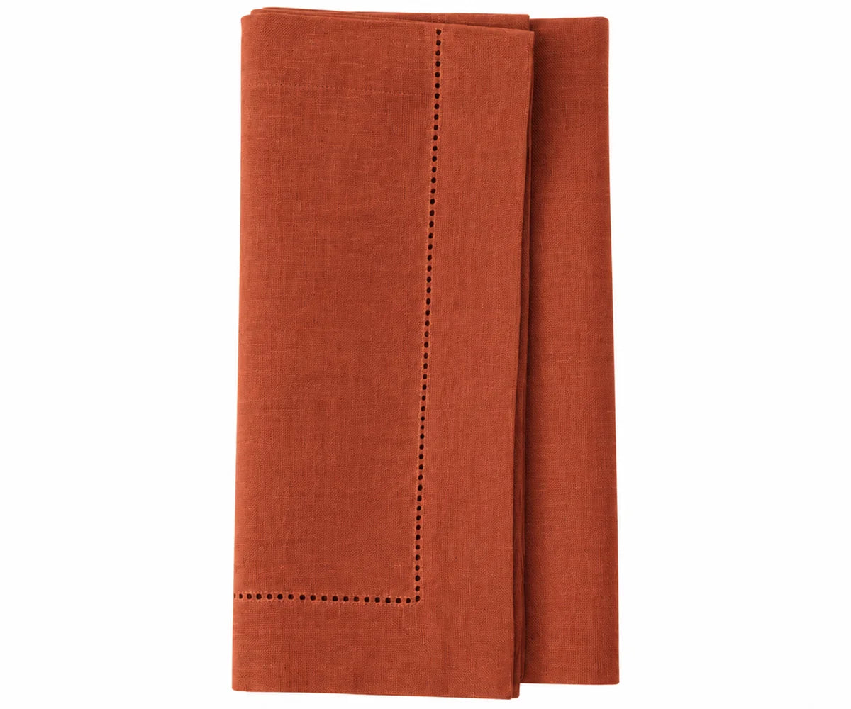 Rust linen napkins with hemstitched borders, premium cloth dinner napkins for elegant table settings.