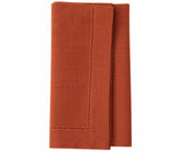 Rust linen napkins with hemstitched borders, premium cloth dinner napkins for elegant table settings.
