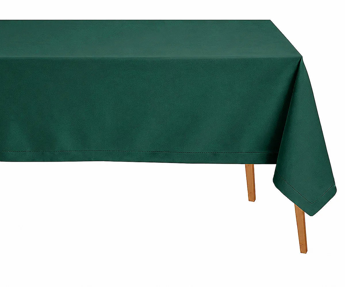 Green pure linen tablecloth with refined hemstitched finish arranged on a rustic dining table for fresh botanical-inspired décor.