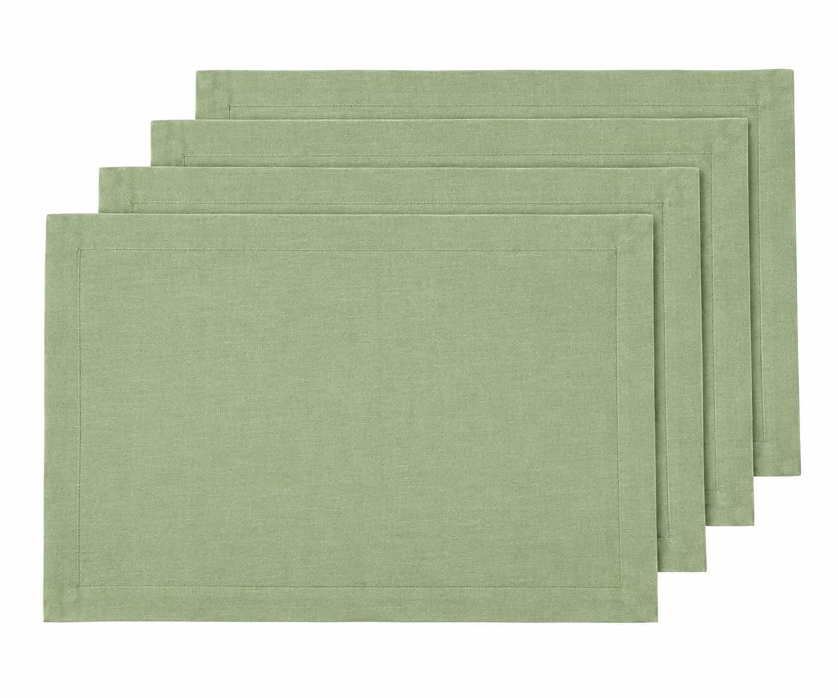 Sage green linen placemats on a dining table with elegant table décor, green placemats for dining table, linen table mats.