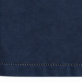 Close-up of navy blue cotton linen tablecloth with hemstitched border detail.