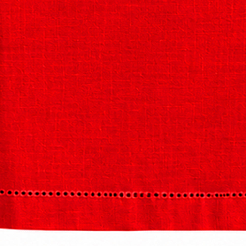 Close-up of red cotton linen tablecloth with a detailed hemstitched border.