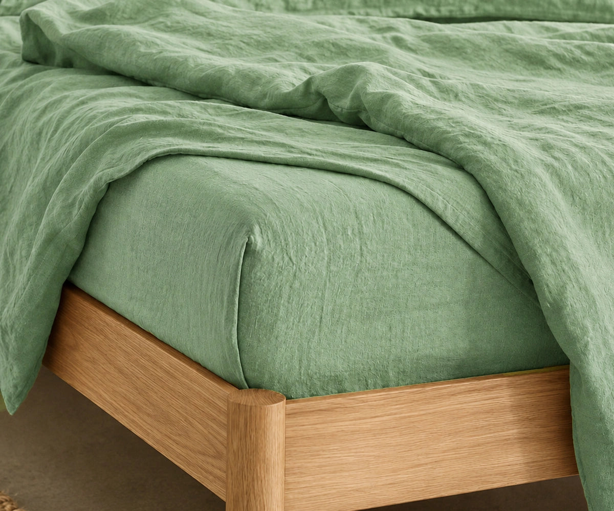 Soft Sage Green fitted sheet in 100% linen for cooling comfort, modern bedroom décor, and year-round sleep