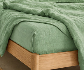 Soft Sage Green fitted sheet in 100% linen for cooling comfort, modern bedroom décor, and year-round sleep