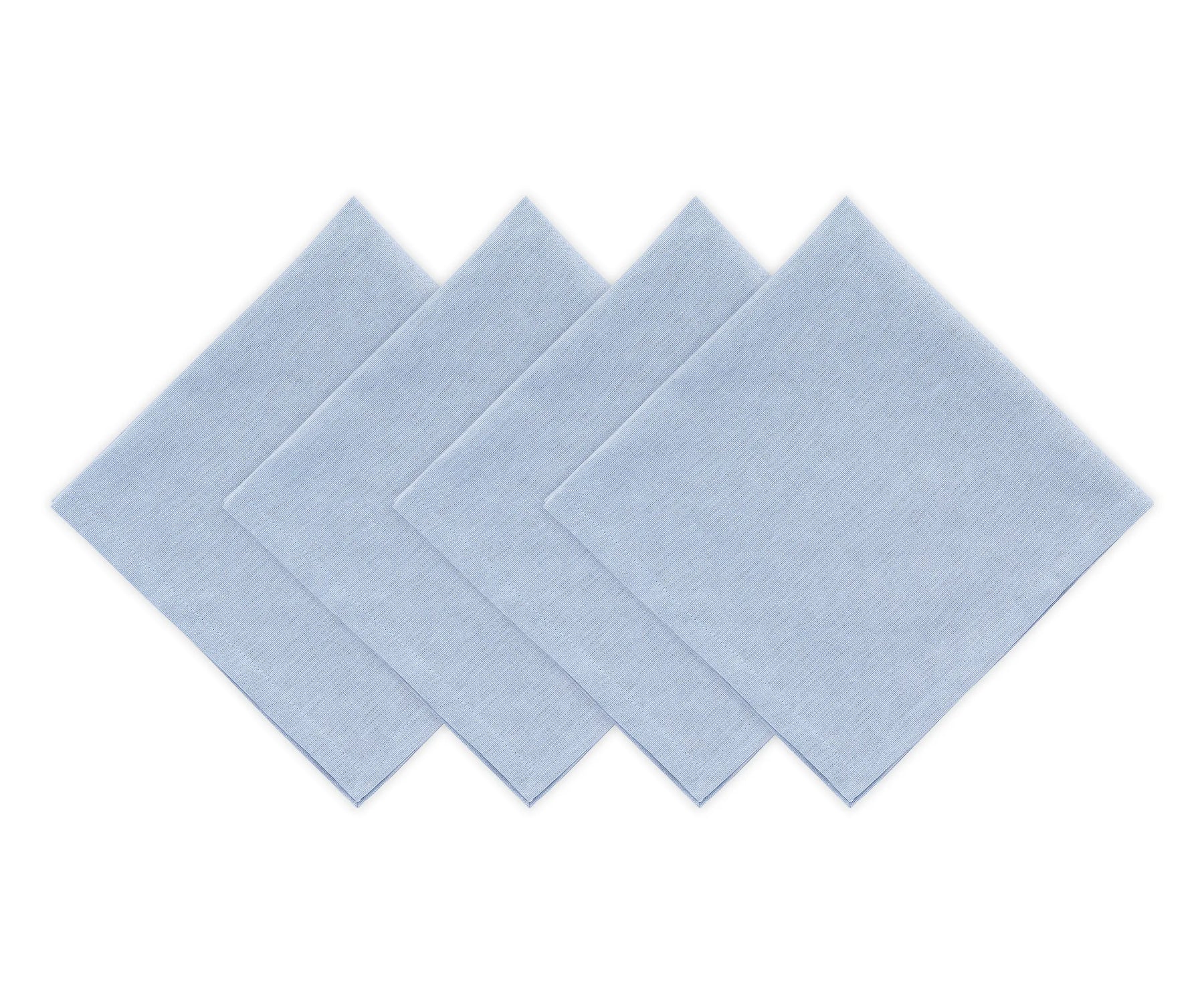 Reusable light blue cotton dinner napkins arranged with white dinnerware
