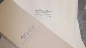 Pipe scallop napkins featuring fine stitching and scalloped borders, perfect for modern dining tables.