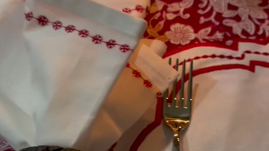 oval cloth placemat displayed on a dining table, highlighting its textured fabric and elegant shape.