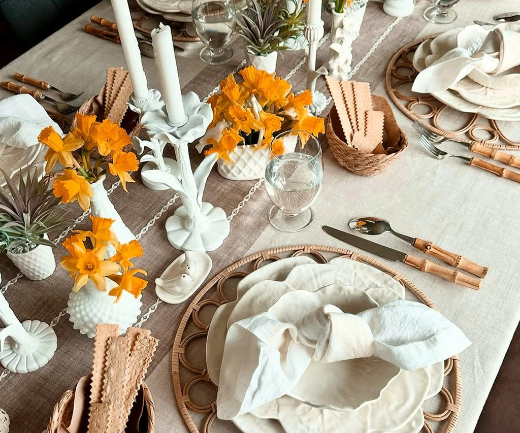Rectangular beige tassel tablecloth draped across a dining table with soft fringed edges