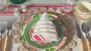 Elegant dining table set with red and white stripe napkins folded neatly.