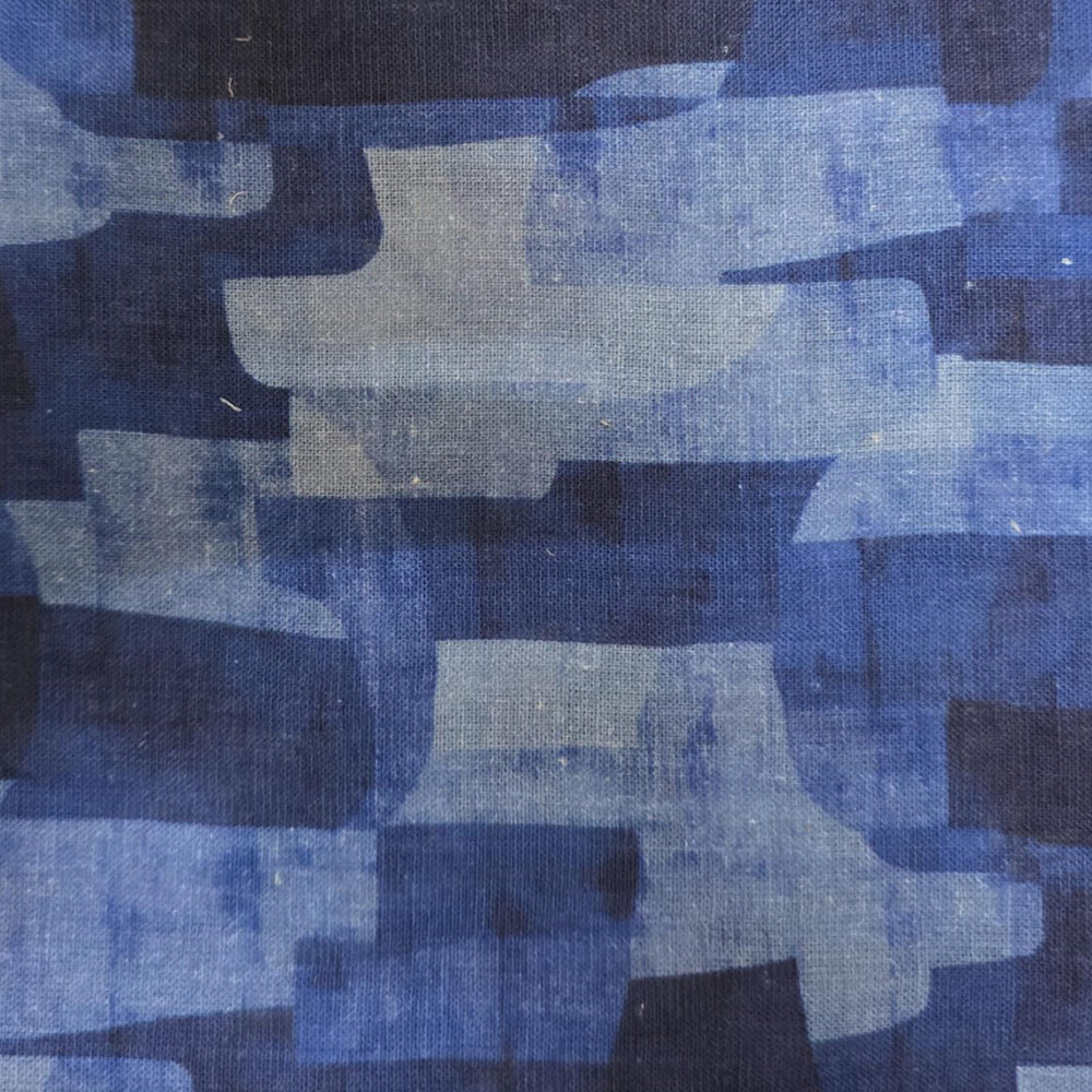 Elegant round tablecloth with repeating nature-inspired design placed over a pedestal dining table.