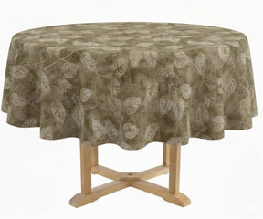 Round table linen with abstract botanical pattern covering a pedestal table in a neutral studio background.