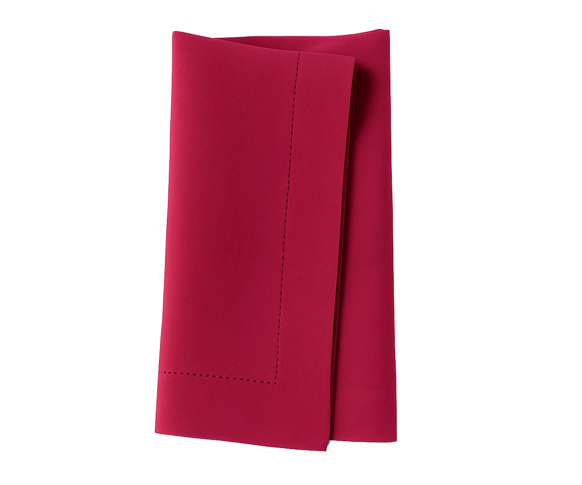Raspberry red cotton napkin with neatly stitched edges, perfect for vibrant dining table settings.