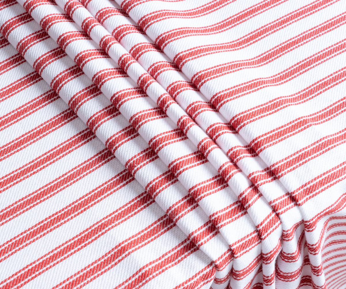 Close-up of red ticking stripe pattern on durable drill weave cotton fabric