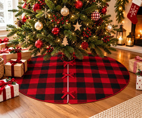 Red and black buffalo plaid Christmas tree skirt with red bow ties under a decorated holiday tree.