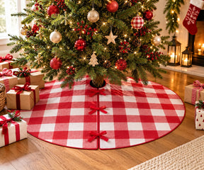 Red and white buffalo plaid Christmas tree skirt with bow ties around a decorated holiday tree.