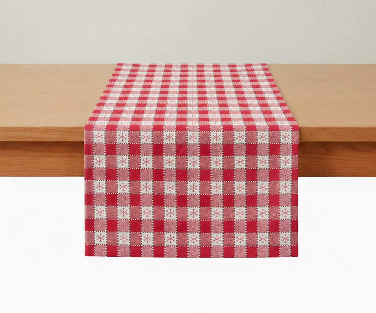 100% cotton Snowflake Check table runner in red and ivory featuring a festive checkered design with snowflake accents for Christmas and holiday table décor.