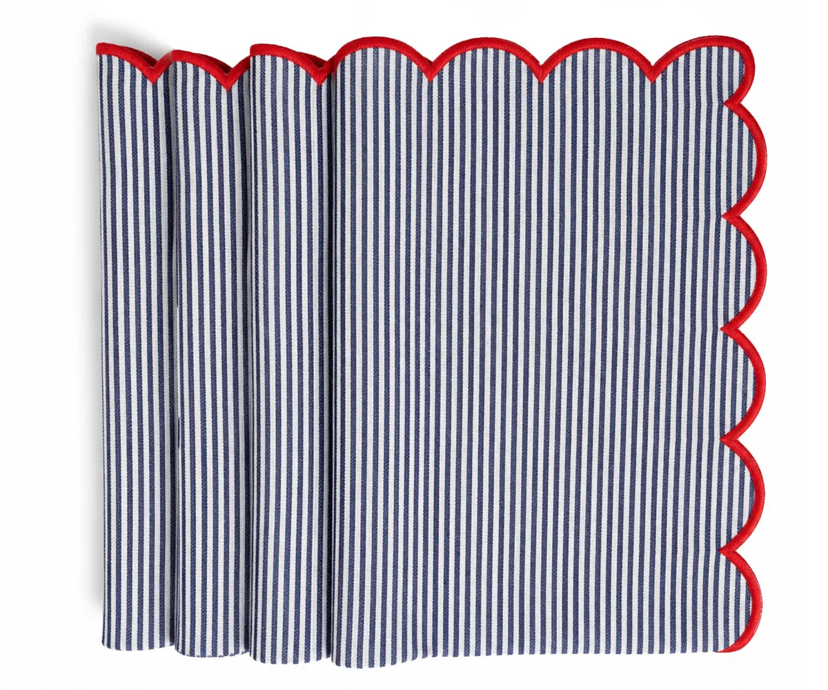 Navy and white striped cloth napkin finished with a contrasting red scalloped trim, neatly folded for table presentation.