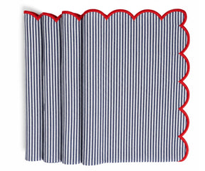 Navy and white striped cloth napkin finished with a contrasting red scalloped trim, neatly folded for table presentation.