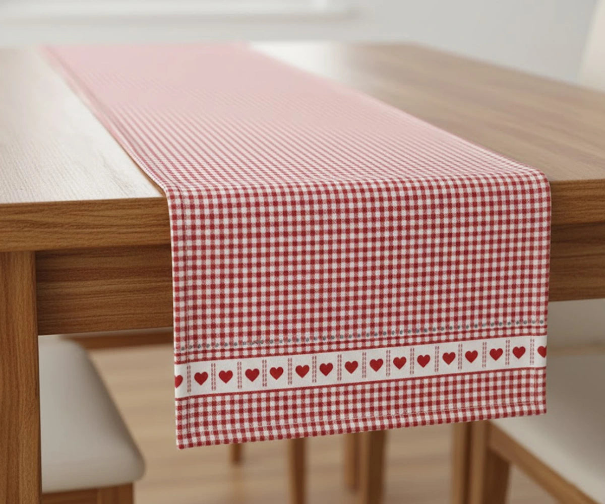 Red and white heart patterned cotton table runner folded on table