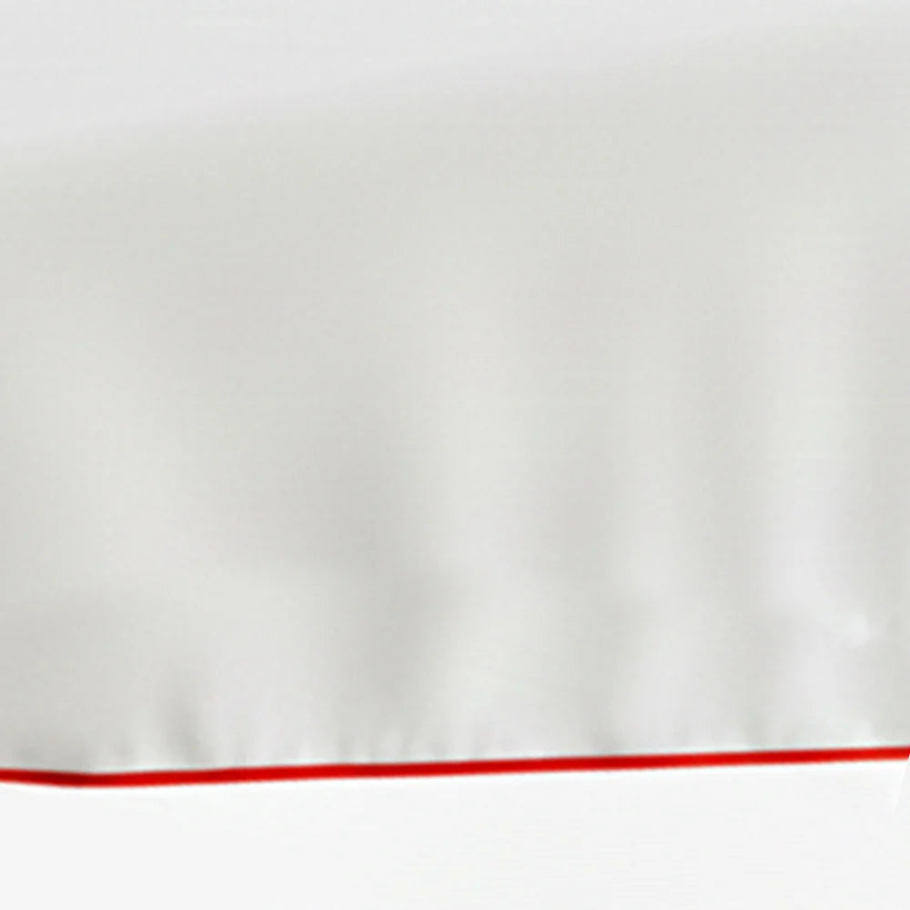 Set of white cotton placemats with red piping