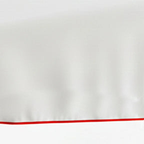 Set of white cotton placemats with red piping