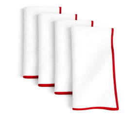 White embroidered cotton napkins accented with a vibrant red merrow edge