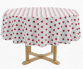 White round tablecloth covered with small red heart patterns, draped over a wooden pedestal table, displayed in a media gallery with a pattern thumbnail preview on the right