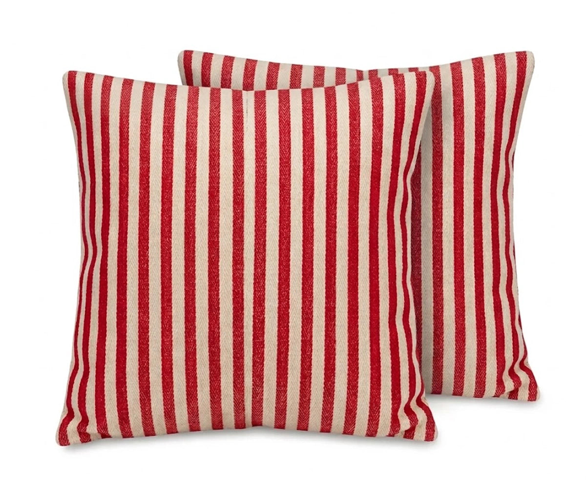 Set of two red and cream vertical striped cushion covers in a heavy herringbone jacquard weave, isolated on a white background.