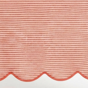 Red striped linen tablecloth material featuring a detailed scallop hem design for kitchen and dining decor.