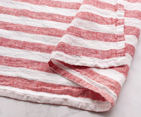 Red and white striped linen kitchen towel with soft woven texture close-up
