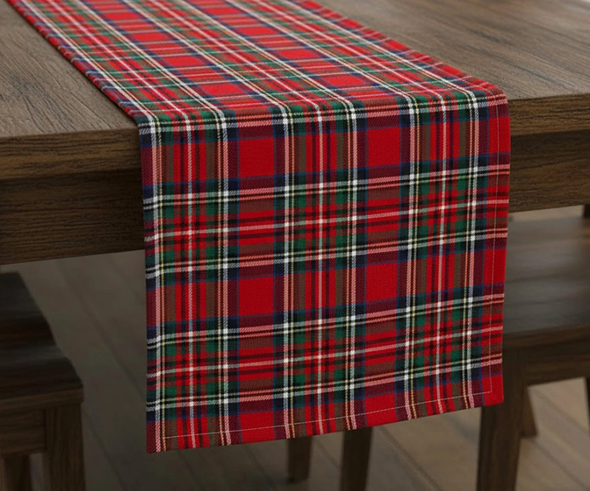 Green and red tartan plaid cotton table runner with white and navy checks adding festive warmth and classic elegance to a holiday dining table.