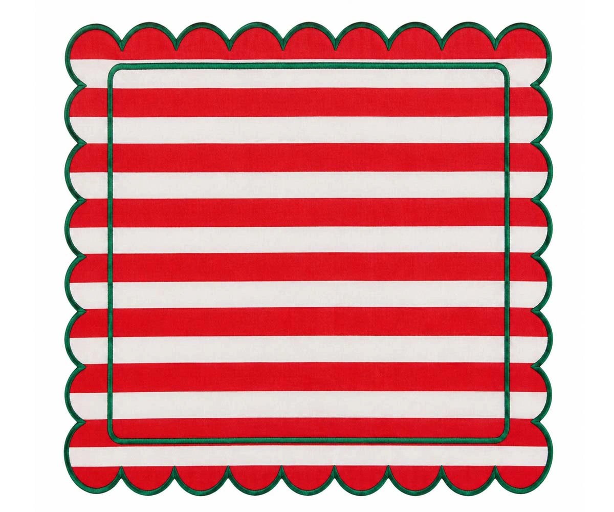 Red and white striped cloth napkin with scalloped edges and green trim for festive dining table decor